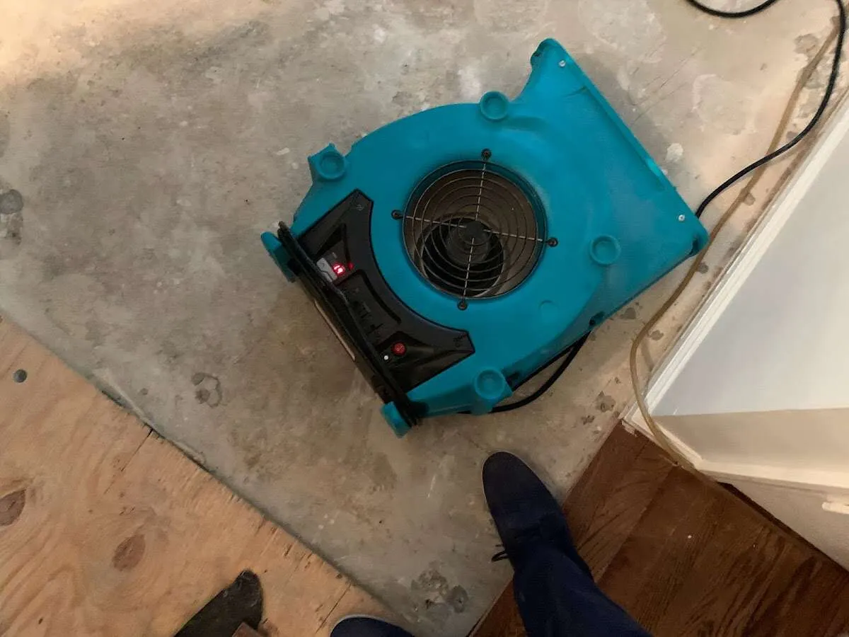 Air mover drying subfloor during Leak Detection & Repair in Grimes